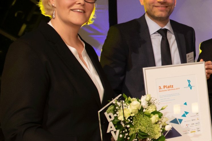 two employees looking into the camera