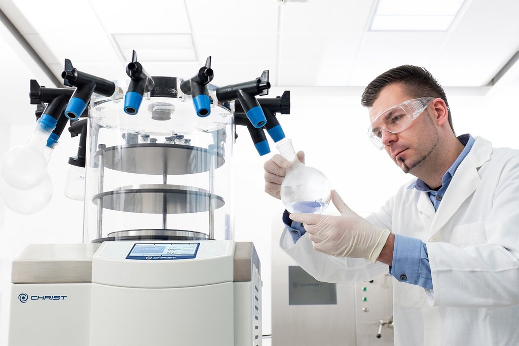 Scientist preparing the freeze dryer for lyophilization