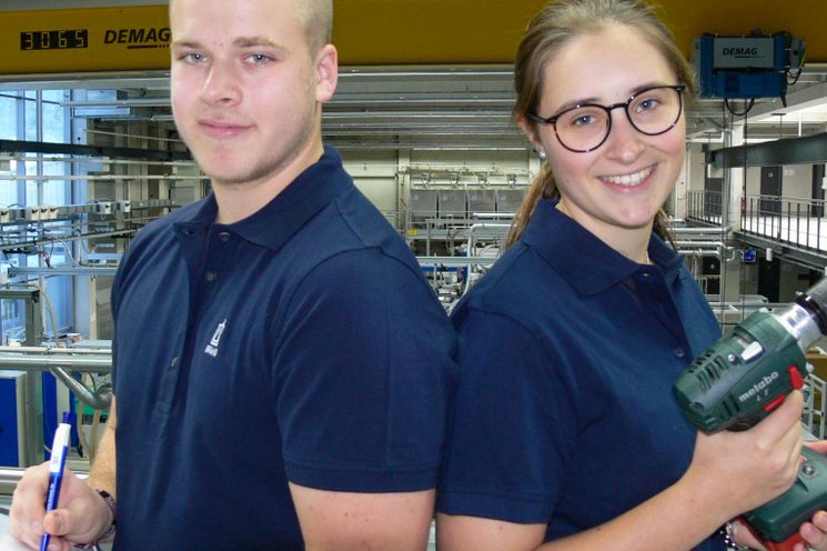 Two apprentices looking into the camera