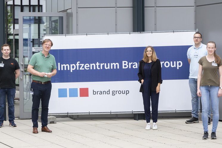 Group of employees standing in front of the camera