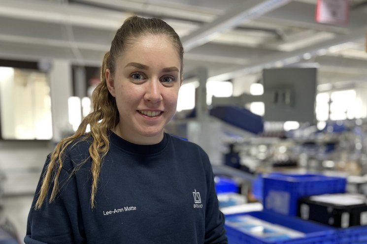 Female employee looks into the camera